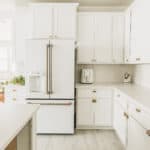 All-white kitchen design with white cabinets and white appliances