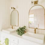 Gold mirrors with rectangle vessel sink and brass faucets