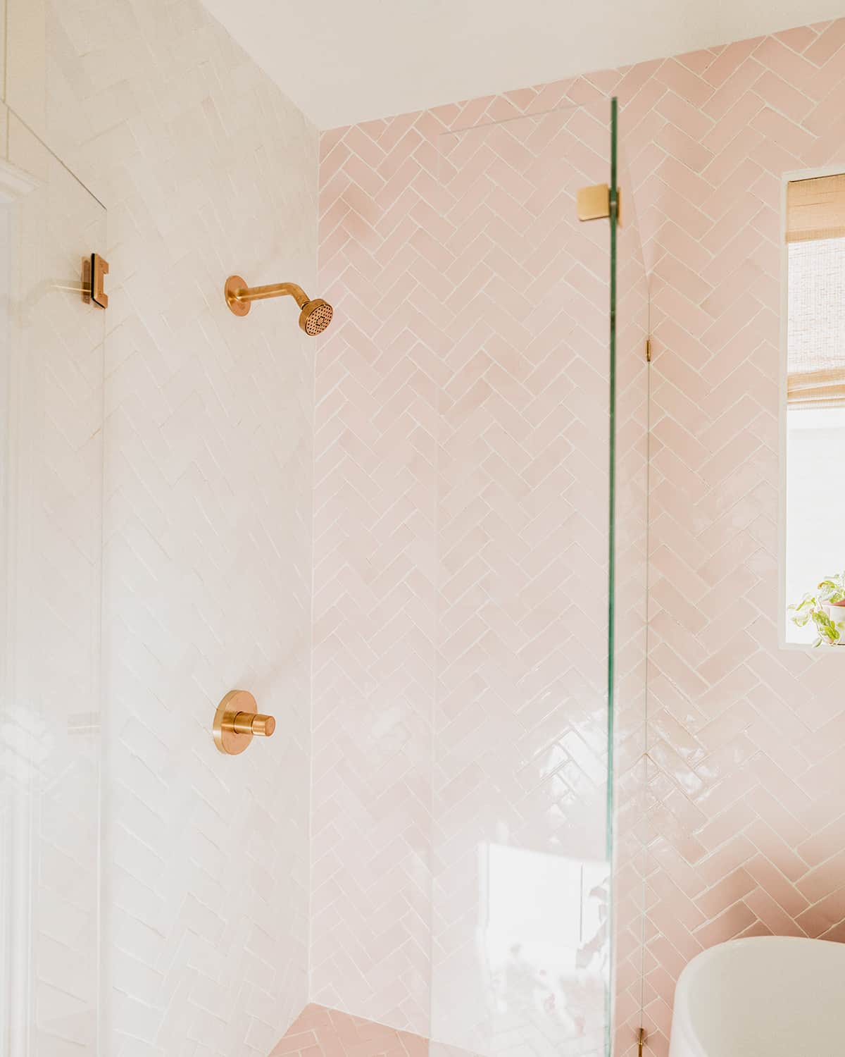 glass shower with brass shower head | pink and white rectangle tiles
